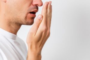 Young Man Checking Bad Breath